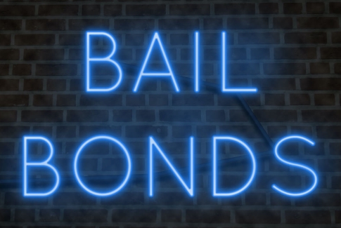 Blue Neon Bail Bonds Sign On Brick Wall