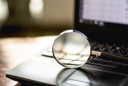 Magnifying Glass On Laptop Computer