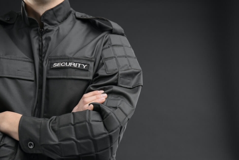 Man In Black Security Uniform Folding Arms Lrg